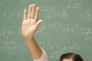 Student hand raised in classroom