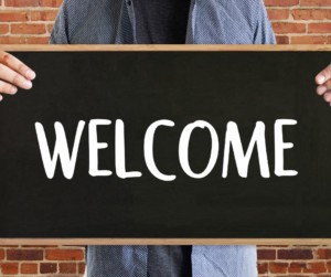 Welcome sign held by person