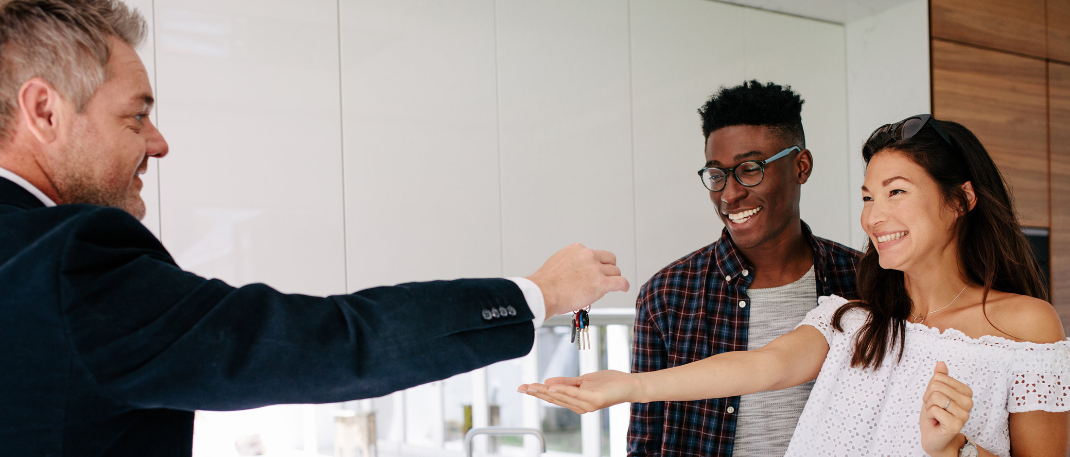 Couple with realtor getting keys to new house