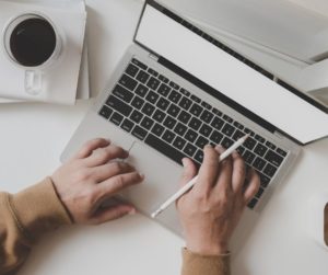 Computer with hands and pen