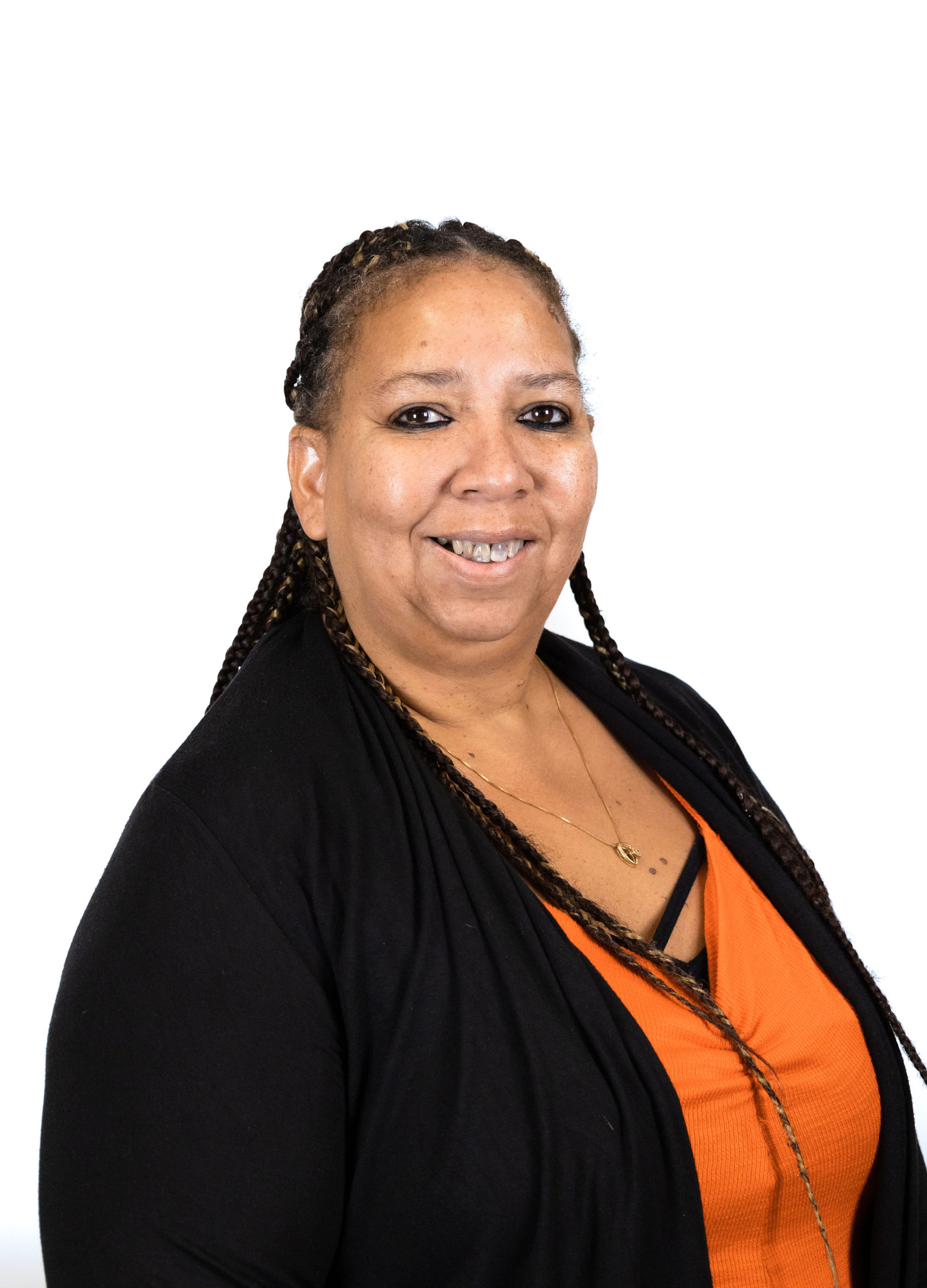 Smiling woman wearing black jacket and orange top